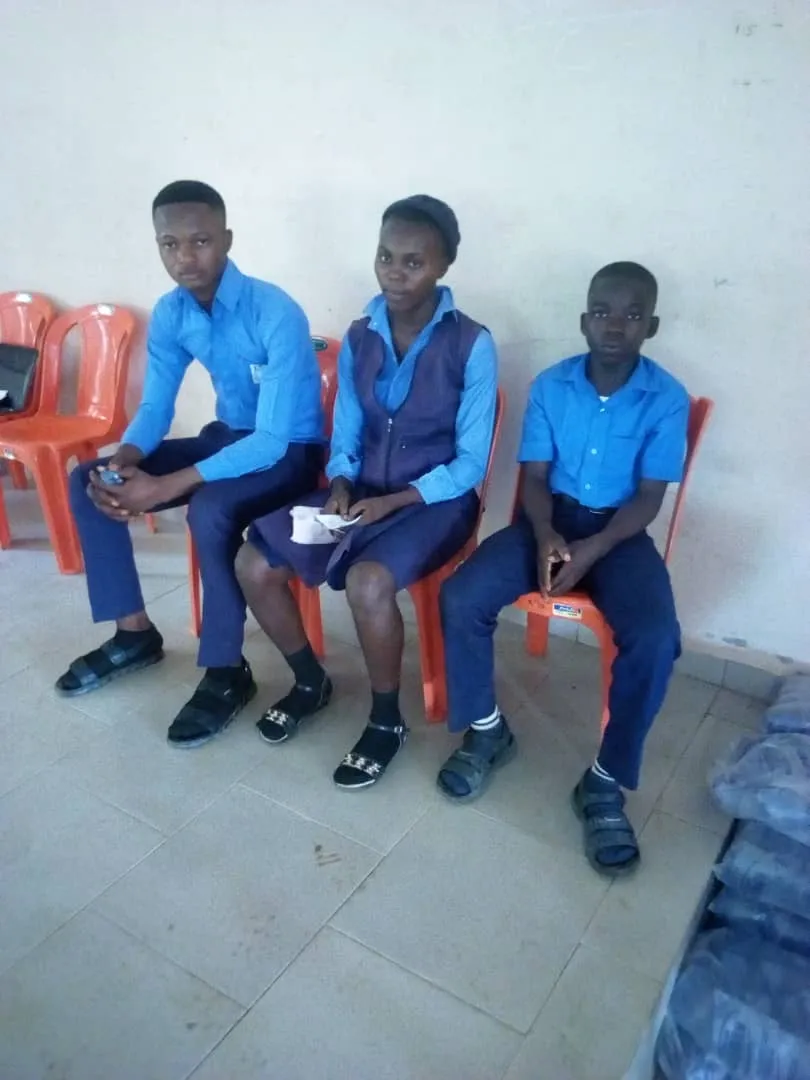The Community Secondary School team seated in their blue uniforms