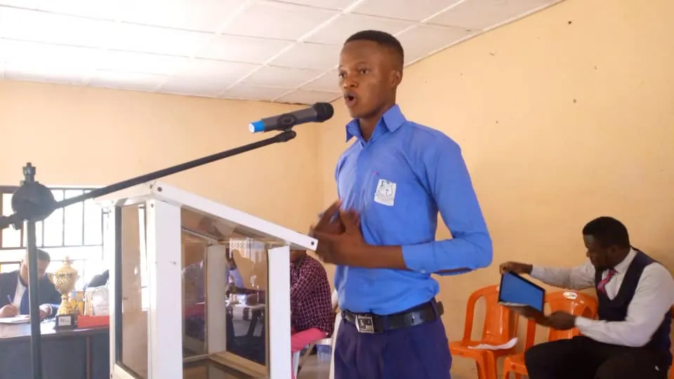 A Community Secondary School speaker in blue at the lectern