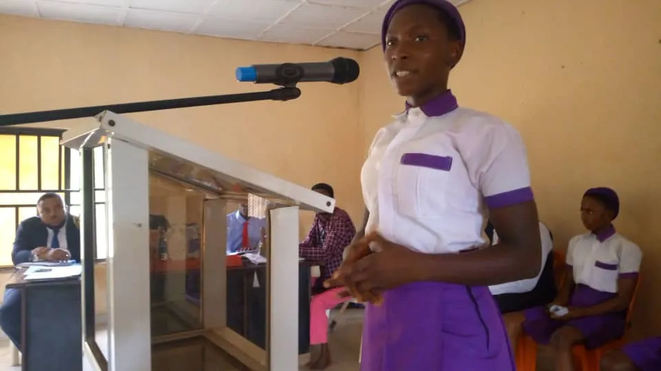 A New Haven Model Secondary School speaker at the lectern
