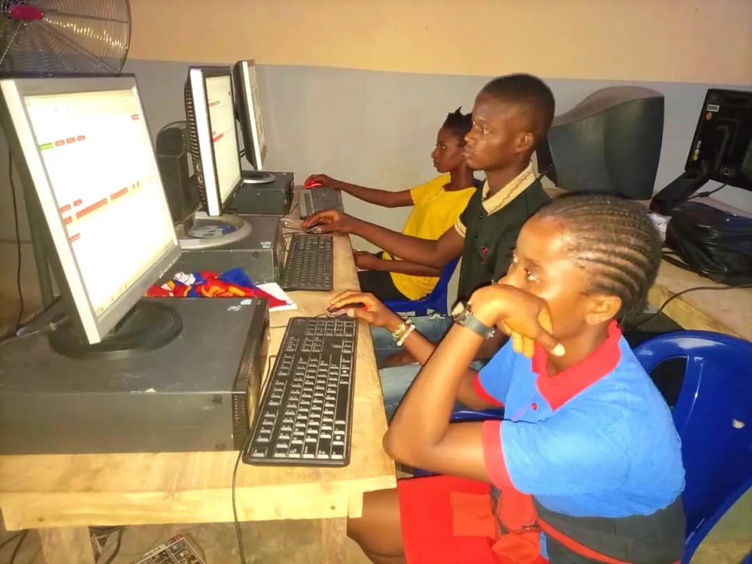 Students practising at computers during a training session