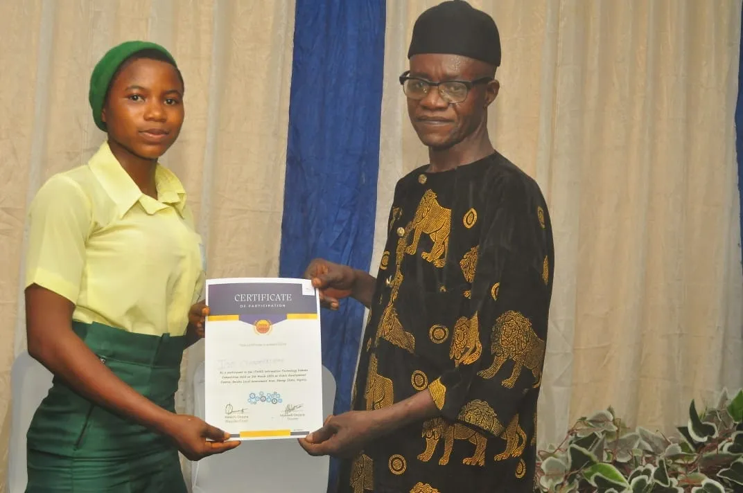 A student receives her certificate of participation