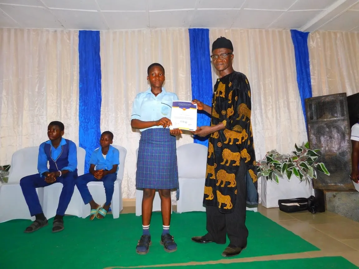 A student receives a certificate on stage