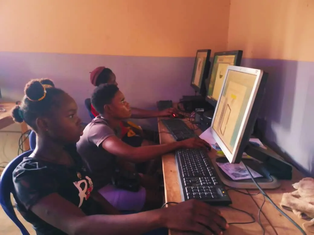 Two girls work together on a computer drawing exercise