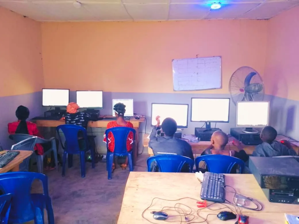 A classroom of students at rows of computers with every screen lit