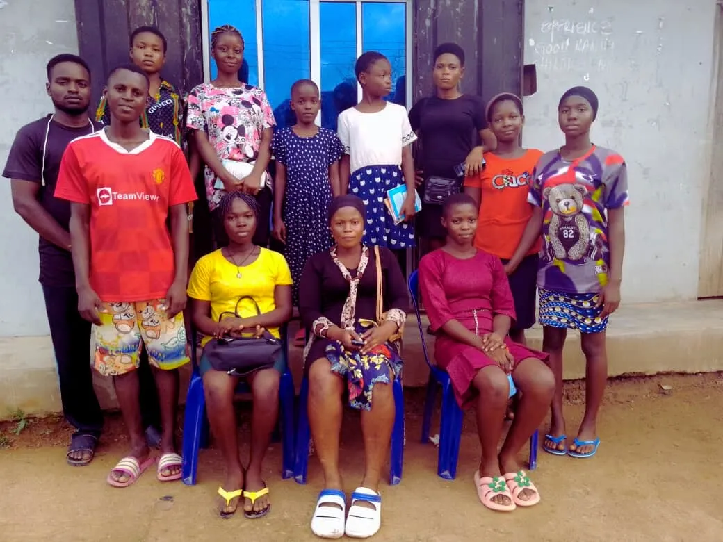 An IT4YUS class group stands together outside the centre
