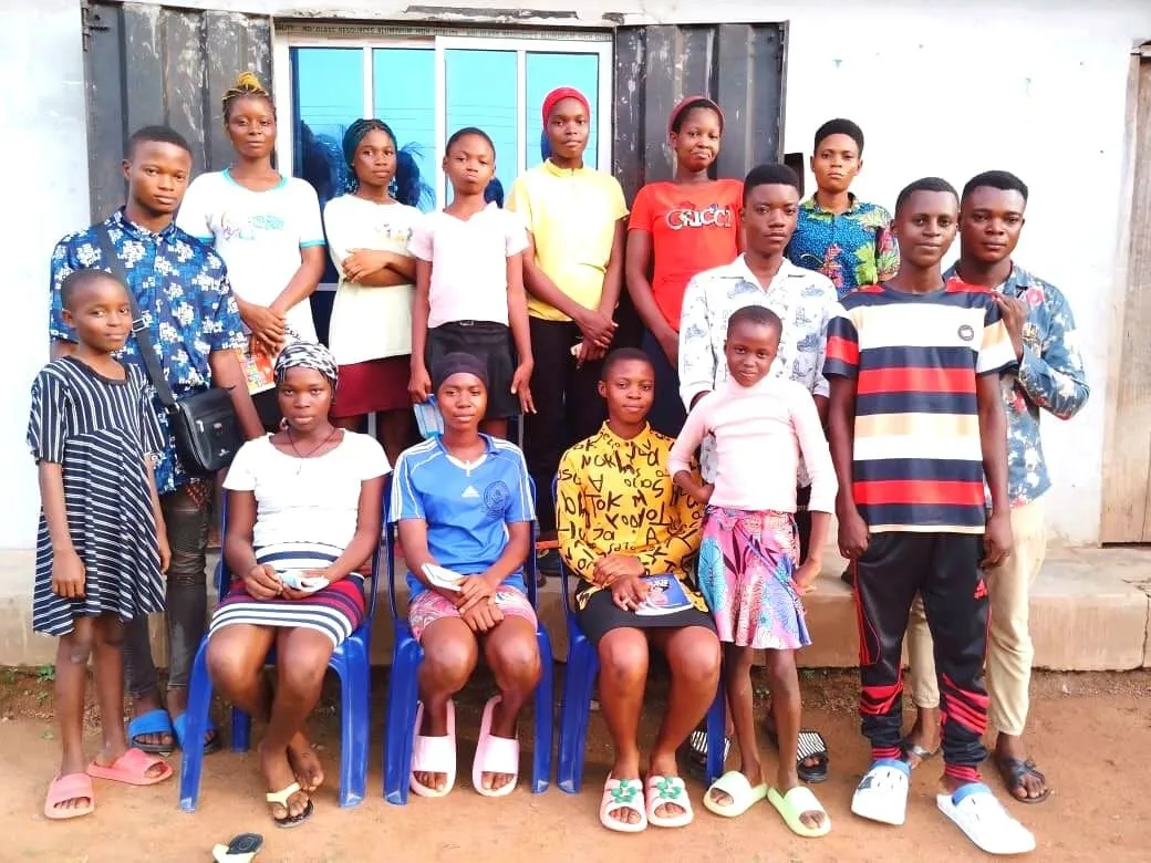 A smiling group of IT4YUS students and trainers outside the centre