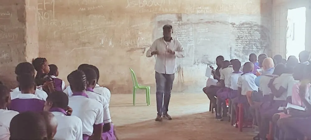 A trainer teaches a hall full of students