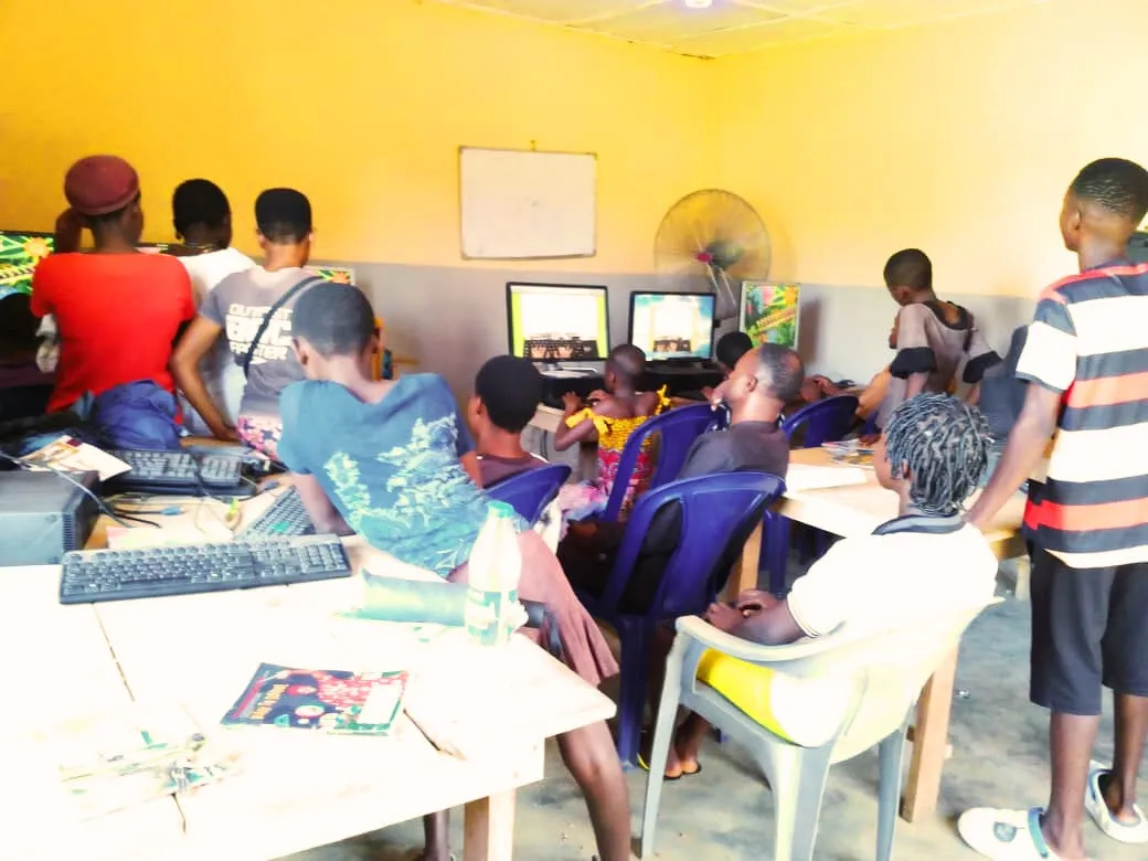 A group of students gathered around computers in the training room